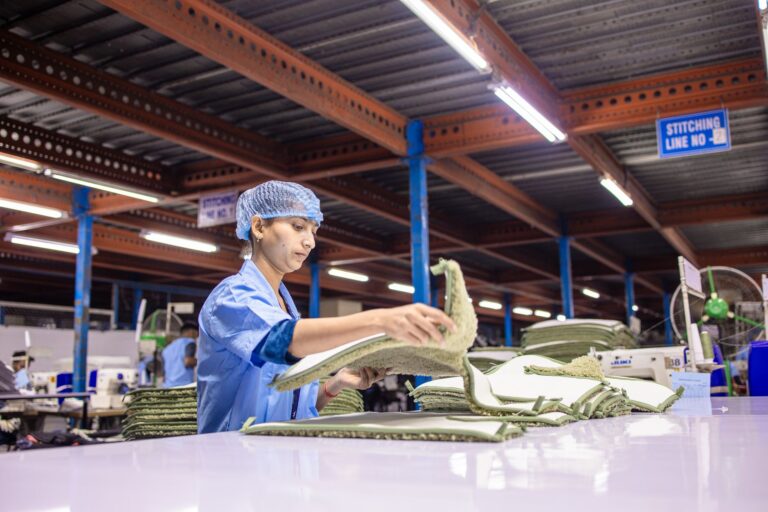 Workers assembling sneakers on a factory production line