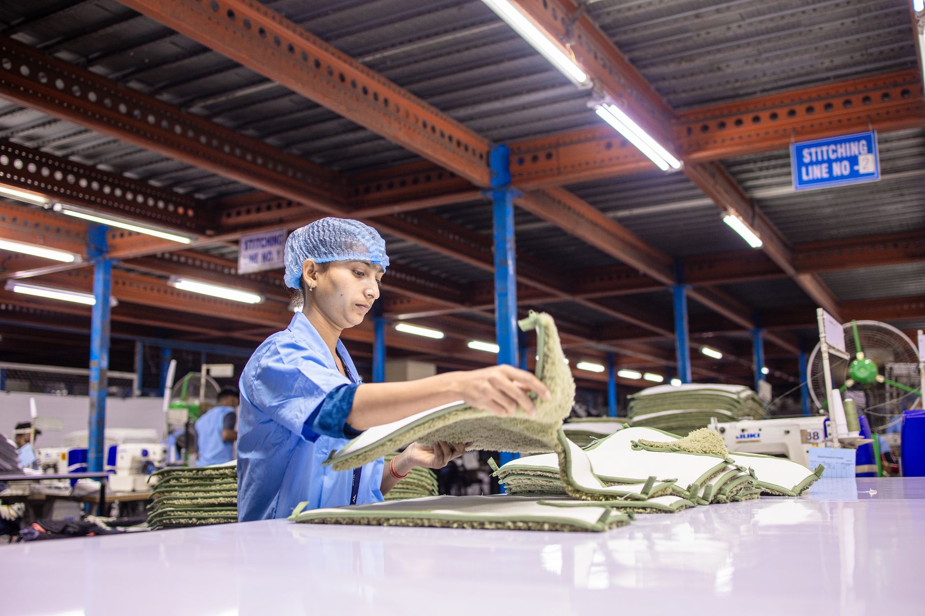 Workers assembling sneakers on a factory production line