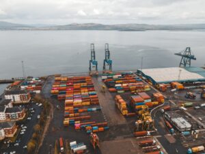 Large container ships docked at a deep-water terminal with stacked shipping containers