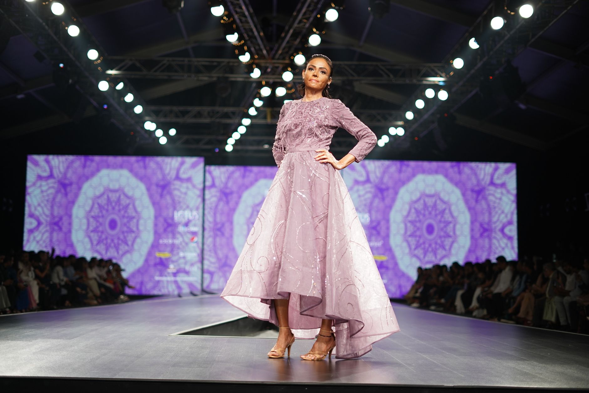 Model walking a spring runway show in a delicate embellished evening gown