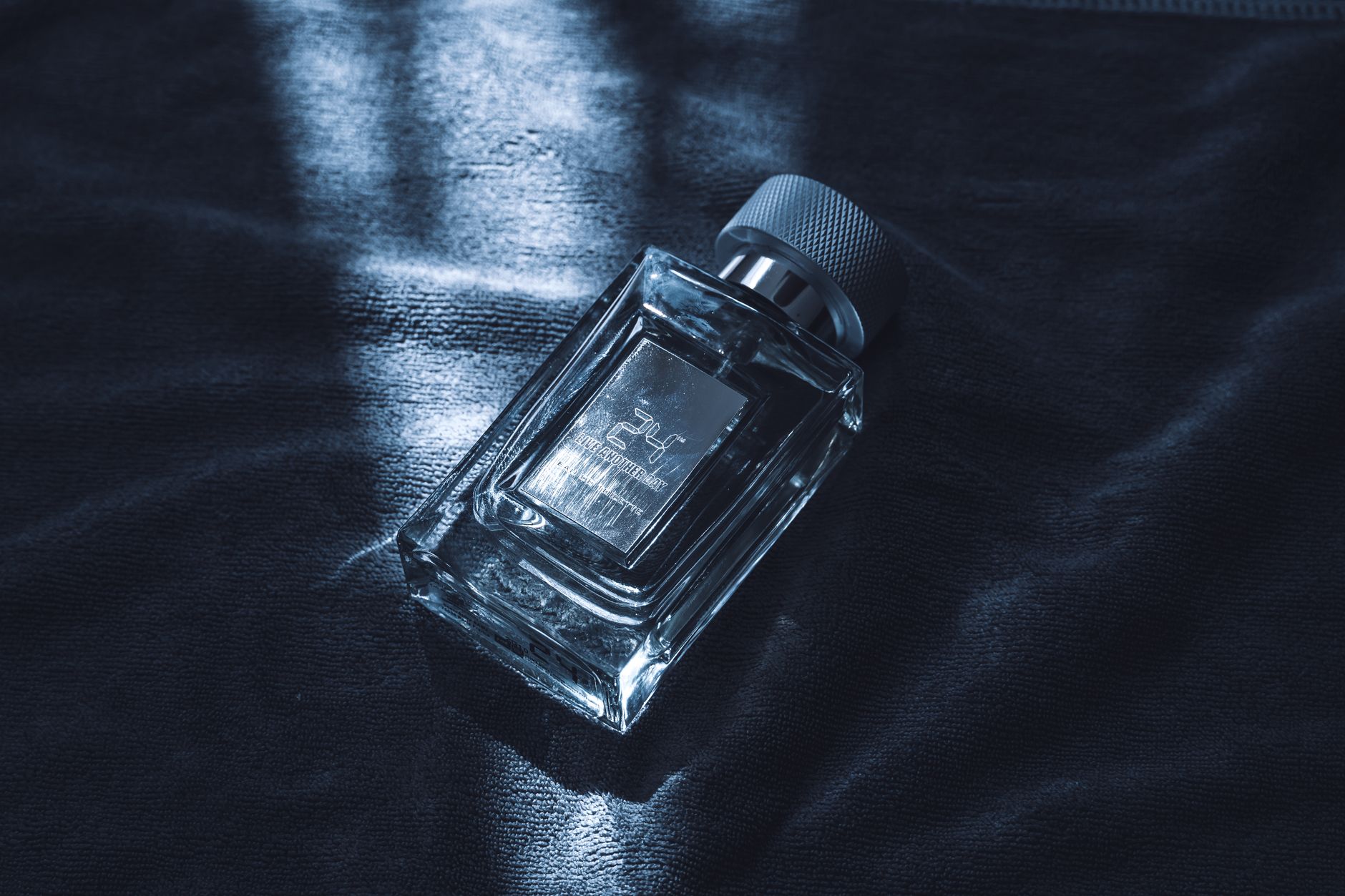 Close-up of a perfume mist bottle on a vanity countertop