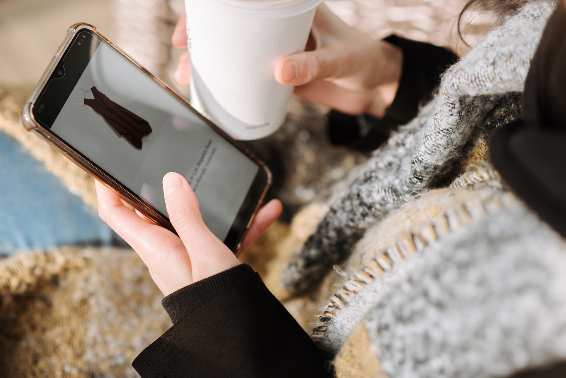 Person using a smartphone to browse a resale shopping app