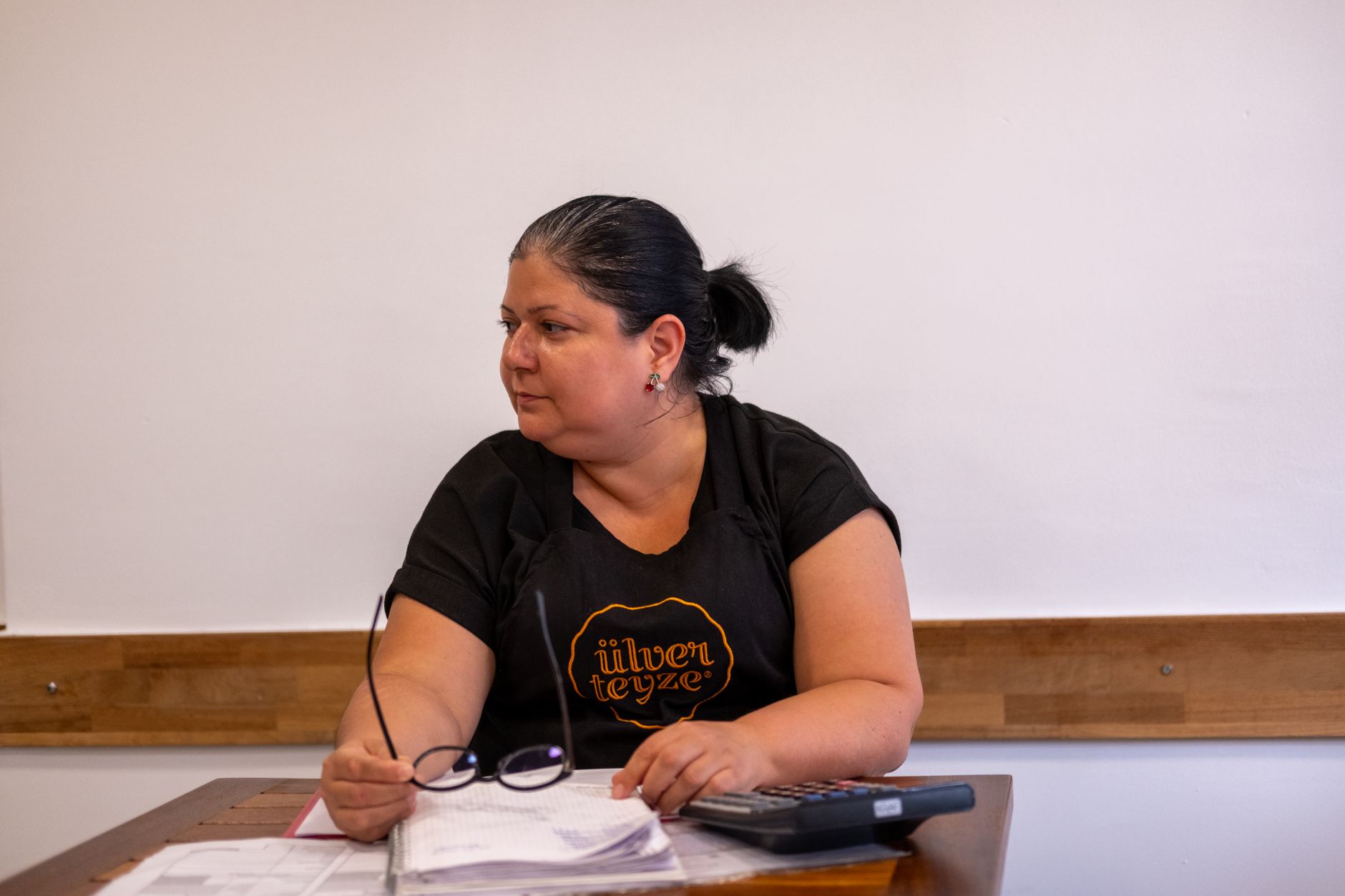 Woman writing at a desk, representing open essay submissions for a literary magazine