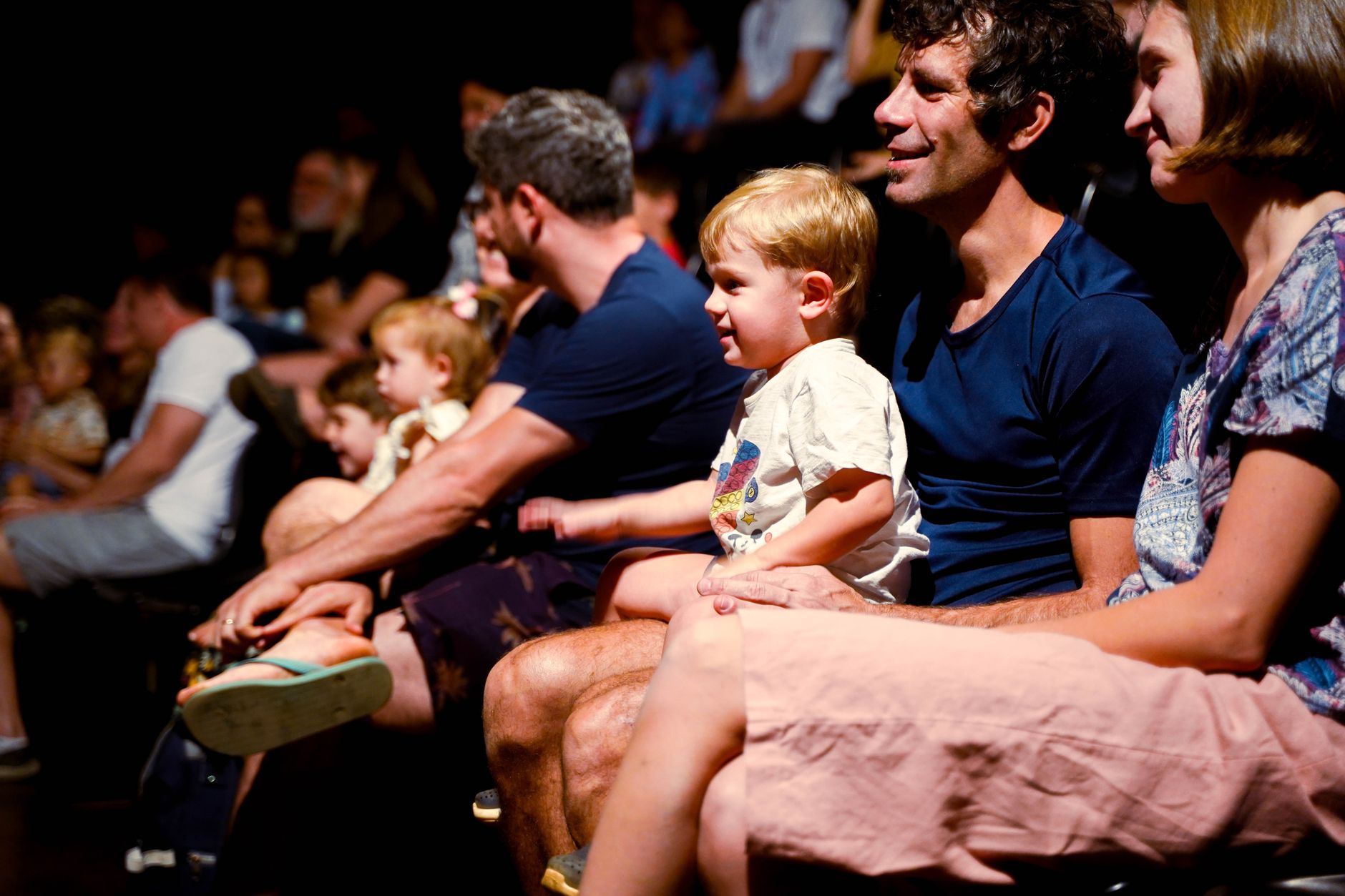 Elegantly dressed guests seated at a high-fashion event