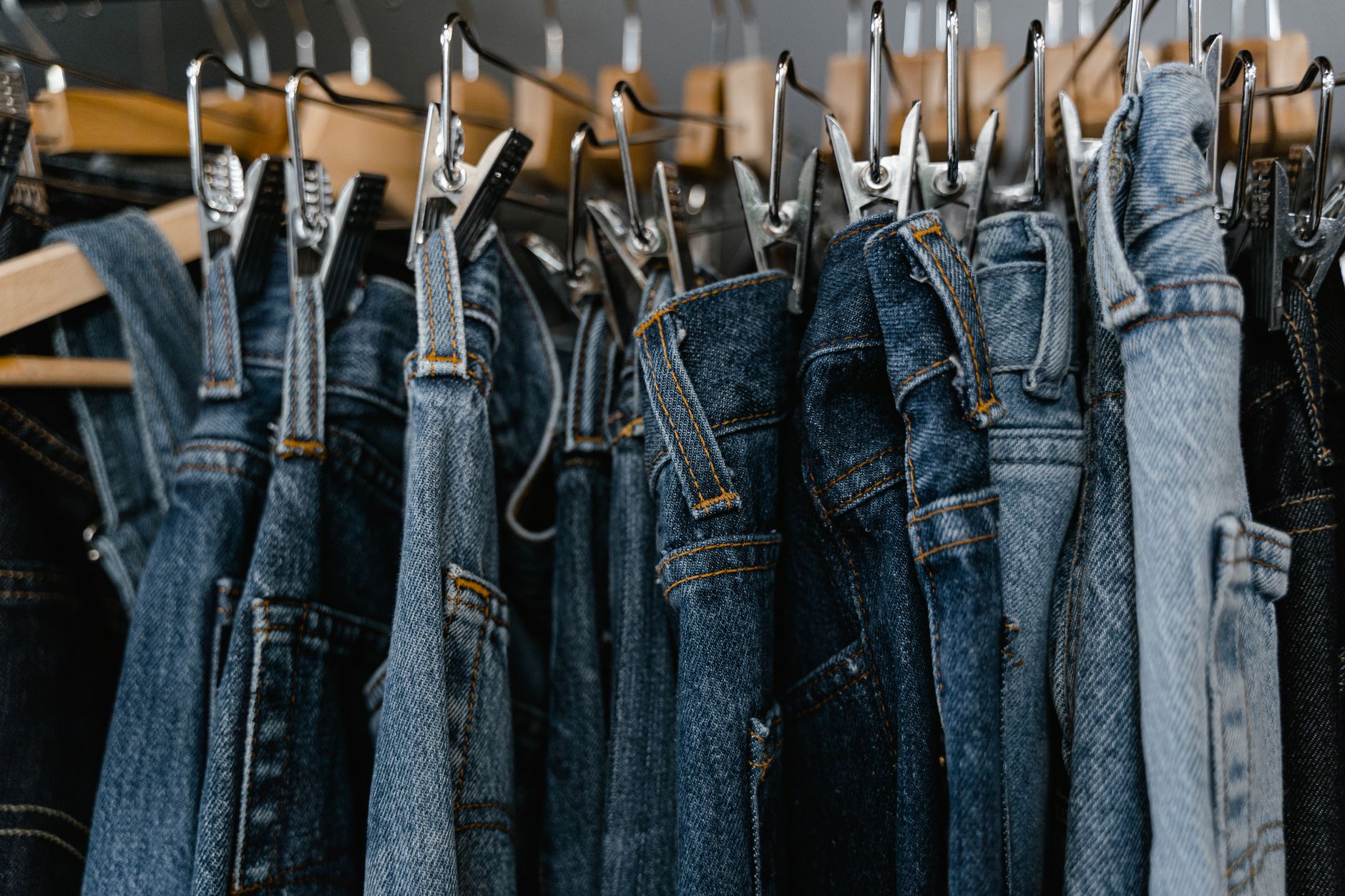 Woman browsing denim styles in a clothing store