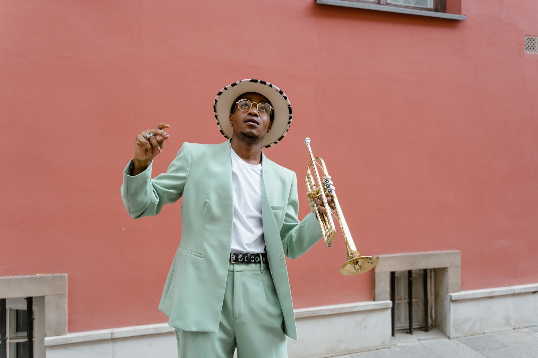 Musician playing trumpet on a lit performance stage