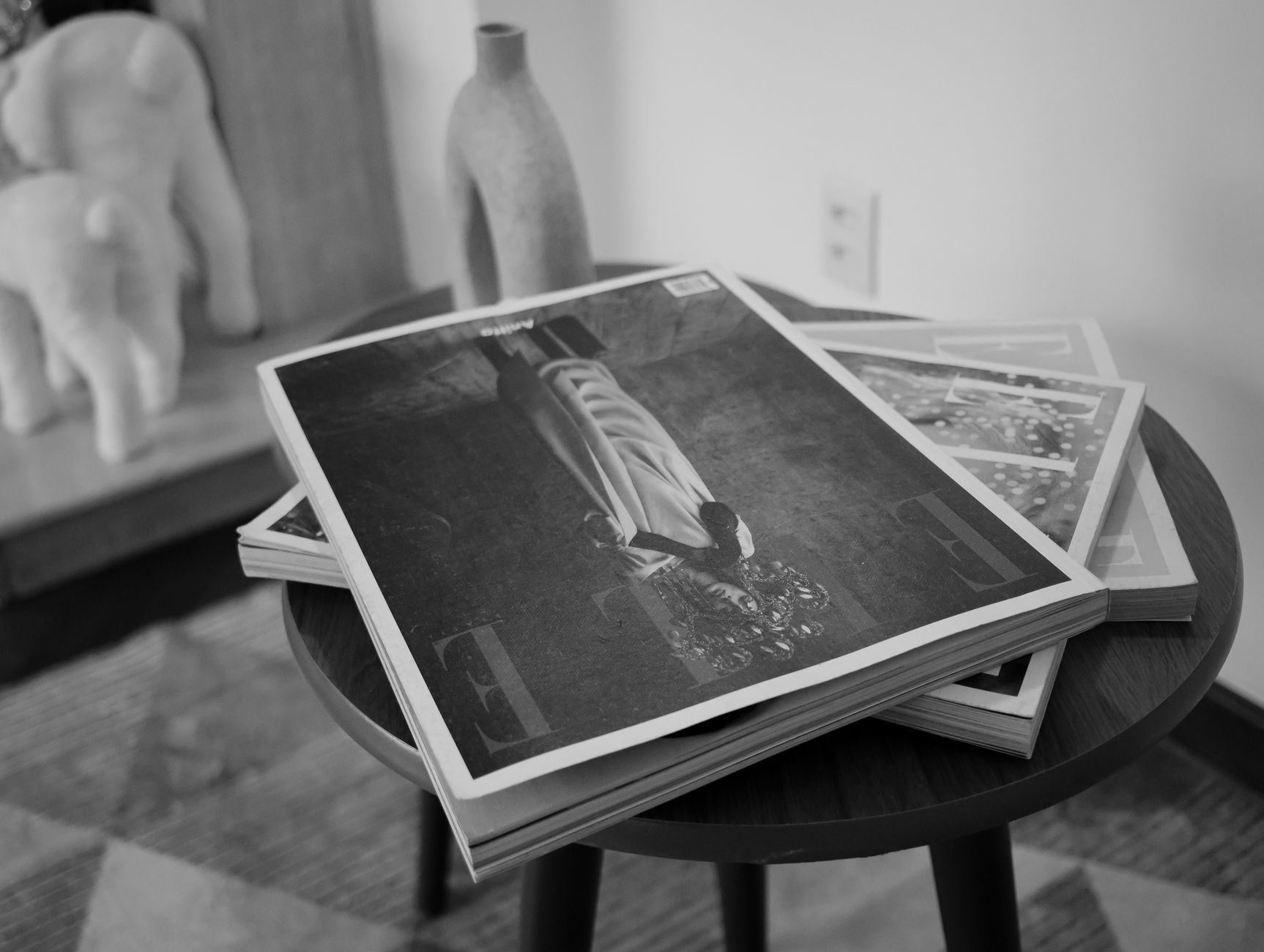 Printed magazine pages fanned out, representing a fashion brand's editorial publication