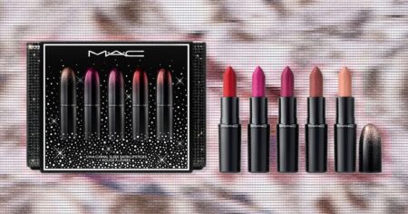 Assorted holiday beauty gift sets arranged on a festive background