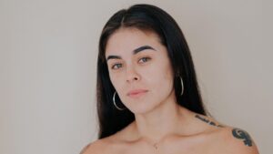 Woman looking directly at camera with a confident, open expression, representing body autonomy after mastectomy